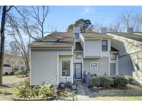 Exterior of charming light gray townhome with well-manicured landscaping at 2757 Jobee Dr # 1101, Charleston, SC 29414