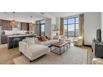 Bright living room with comfy sectional sofa, large windows, and city view at 5 Gadsdenboro St # 410, Charleston, SC 29401