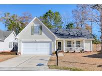 Tan house with white garage door and porch at 5344 Tidewater Dr, North Charleston, SC 29420