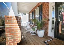 Inviting front porch with rocking chairs and brick columns at 9504 Markley Blvd, Summerville, SC 29485