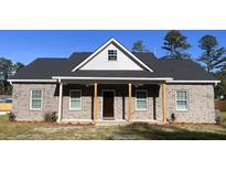 Gray brick home with a front porch and landscaping at 100 Del Ray Dr, Walterboro, SC 29488