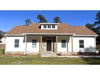 Newly constructed home with white siding, stone accents, and a brown roof at 101 Brien, Walterboro, SC 29488