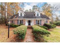 Brick ranch house with a landscaped yard and walkway at 108 Fairway Dr, Summerville, SC 29483