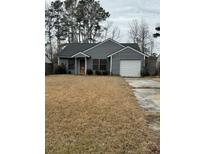 Gray one-story house with attached garage and dry brown lawn at 1270 Maryland Dr, Ladson, SC 29456
