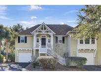 Charming yellow house with white trim and a two-car garage at 1517 Soliel Ct, Mount Pleasant, SC 29464