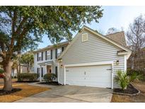 Two-story house with gray siding, white garage door, and landscaping at 1644 Jorrington St, Mount Pleasant, SC 29466