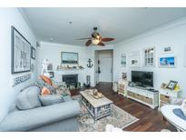 Bright living room with hardwood floors, fireplace, and comfy seating at 1928 Chatelain Way, Mount Pleasant, SC 29464