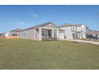 Gray house with white columns and a two-car garage, featuring a well-manicured lawn at 286 W Bradford Pointe Dr, Summerville, SC 29486