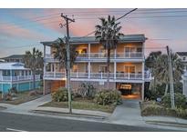 Two-story beach home with wrap-around porch and ocean views at 309 Palmetto Blvd, Edisto Island, SC 29438