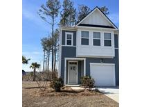 Two-story house with gray siding, white accents, and a two-car garage at 413 Trotters Ln, Moncks Corner, SC 29461
