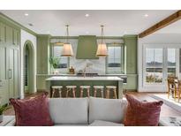 Gourmet kitchen boasts green cabinetry, marble countertops, and a large island at 434-1 Shannon Dr, Mount Pleasant, SC 29464