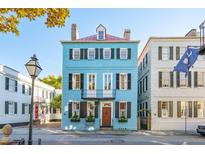 Charming three-story home with blue facade and black shutters at 49 Tradd St, Charleston, SC 29401