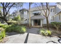 Inviting light gray exterior condo building with lush landscaping and walkway at 5543 Green Dolphin Way, Kiawah Island, SC 29455