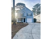 Two-story light blue house with a white garage door and front porch at 8781 Red Oak Dr, North Charleston, SC 29406