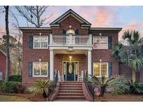 Brick home with a front porch, walkway, and landscaping at 8795 E Fairway Woods Circle, Charleston, SC 29420