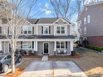 Two-story townhome with gray siding, front porch, and driveway at 9159 Parlor Dr, Ladson, SC 29456