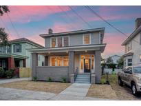 Charming two-story home with gray brick facade and a welcoming front porch at 929 Rutledge Ave, Charleston, SC 29403