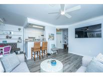 Bright living room features grey sectional sofa, coffee table, and hardwood floors at 1014 Rosewood Ln, Mount Pleasant, SC 29464