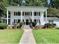 Two-story white house with columns, a walkway, and lush lawn at 109 Quaker Rd, Saint George, SC 29477