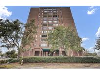 Brick building exterior with landscaping and entrance at 14 Lockwood Dr # 6H, Charleston, SC 29401