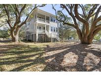 Two-story house exterior with gray siding, large windows, and a wraparound porch at 1461 Lieben Rd, Mount Pleasant, SC 29466