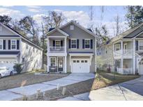 Two-story house with a gray exterior, white trim, and a two-car garage at 153 Instructor Ct, Ladson, SC 29456