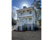 Two-story light gray house with white accents, front porch, and landscaped yard at 1892 Grover Rd, Johns Island, SC 29455