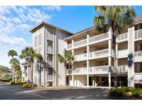 Lowcountry style building with balconies and palm trees at 2014 Long Bend Dr, Seabrook Island, SC 29455