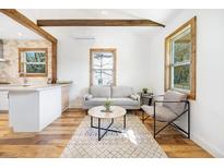 Open living room with hardwood floors, exposed beams, and a cozy seating area at 2963 Alabama Dr, North Charleston, SC 29405