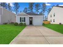 Charming one-story home with a gray exterior, landscaped lawn, and a two-car garage at 415 Broad Elm Way, Summerville, SC 29486
