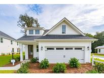 Charming white farmhouse with a two-car garage and well-manicured landscaping at 457 Eagleview Dr, Moncks Corner, SC 29461
