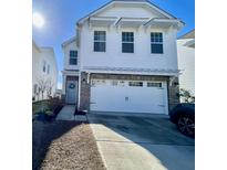 Two-story white house with gray brick accents, two-car garage, and landscaping at 515 Purple Finch Rd, Summerville, SC 29486