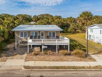 Elevated beach house with a large deck and ocean views at 609 Palmetto Blvd, Edisto Beach, SC 29438