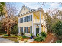 Charming yellow house with gray shutters, landscaped yard, and a welcoming porch at 913 High Nest Lane Ln, Charleston, SC 29412