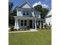 Charming two-story home with a covered front porch and lush landscaping at 106 Gray Pine Ln, Summerville, SC 29483