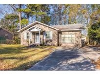Brick ranch house with attached garage and a spacious yard at 1134 S Shadow Dr, Mount Pleasant, SC 29464