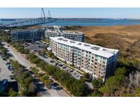 Luxury condos with water views and bridge in background at 155 Wingo Way # 418, Mount Pleasant, SC 29464