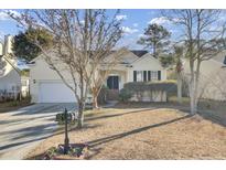 Craftsman style home with attractive landscaping and a two-car garage at 1857 Palmetto Isle Dr, Mount Pleasant, SC 29466