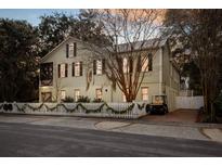 Charming two-story home with white picket fence and festive garland at 209 Bennett St, Mount Pleasant, SC 29464