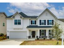 Two-story house with white siding, gray stone accents, and a black front door at 479 Rowley Lane, Summerville, SC 29486