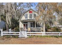 Charming Cape Cod style home with white picket fence and mature landscaping at 600 S Laurel St, Summerville, SC 29483