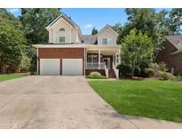 Brick two-story house with two-car garage and landscaped lawn at 8604 Fox Hollow Rd, North Charleston, SC 29420