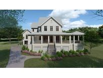 Two-story home with wraparound porch and landscaping at 945 Fish Camp Rd, Charleston, SC 29492