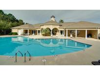 Community pool with a clubhouse and surrounding landscaping at 1300 Park West Blvd # 1001, Mount Pleasant, SC 29466