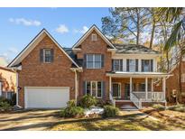 Brick two-story house with a white front door, attached garage, and landscaping at 1333 Chrismill Lane Ln, Mount Pleasant, SC 29466