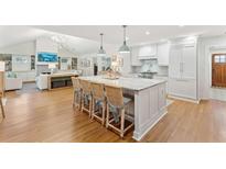 Spacious kitchen with island, white cabinets, and hardwood floors at 1454 Seminole St, Mount Pleasant, SC 29464