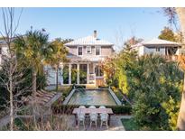 A charming backyard oasis with a tranquil pool and patio area, perfect for relaxation at 17 Bennett St, Charleston, SC 29401