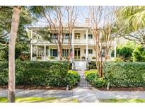 Two-story home with wrap-around porch and lush landscaping at 1738 Ion Ave, Sullivans Island, SC 29482