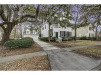 Two-story white house with black shutters, a driveway, and landscaping at 178 Corn Planters St, Charleston, SC 29492