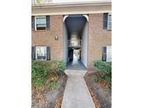 Brick building exterior with covered walkway and access to individual units at 21 Rivers Point Row # 6H, Charleston, SC 29412
